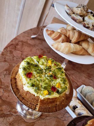 A cake and croissants are on a table