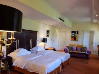 A hotel room with two beds and a couch