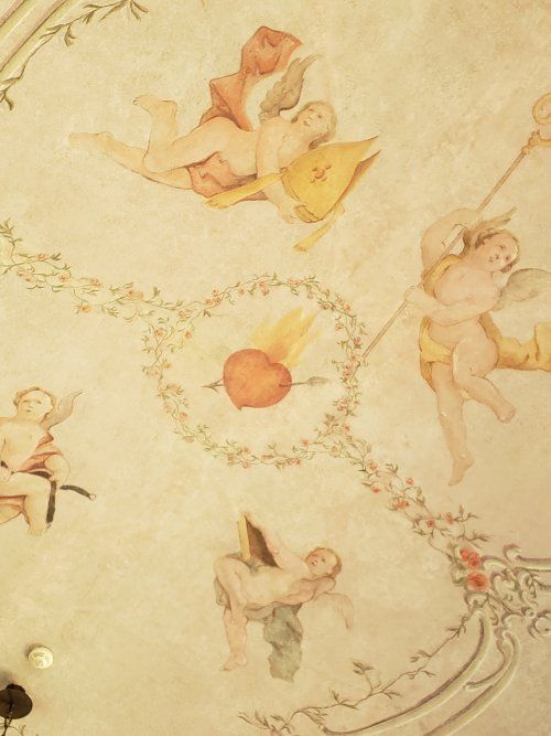 A painting of cherubs with a heart in the middle