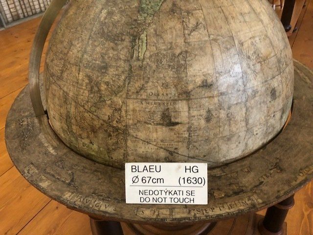 A globe with a sign on it that says do not touch.