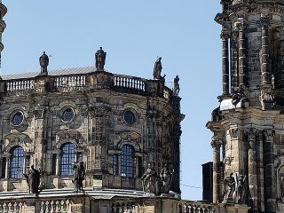 A large building with statues on the top of it