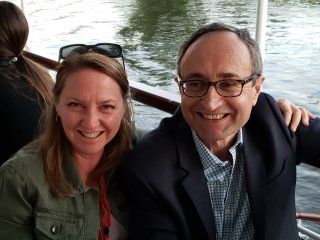 A man and a woman are posing for a picture on a boat.
