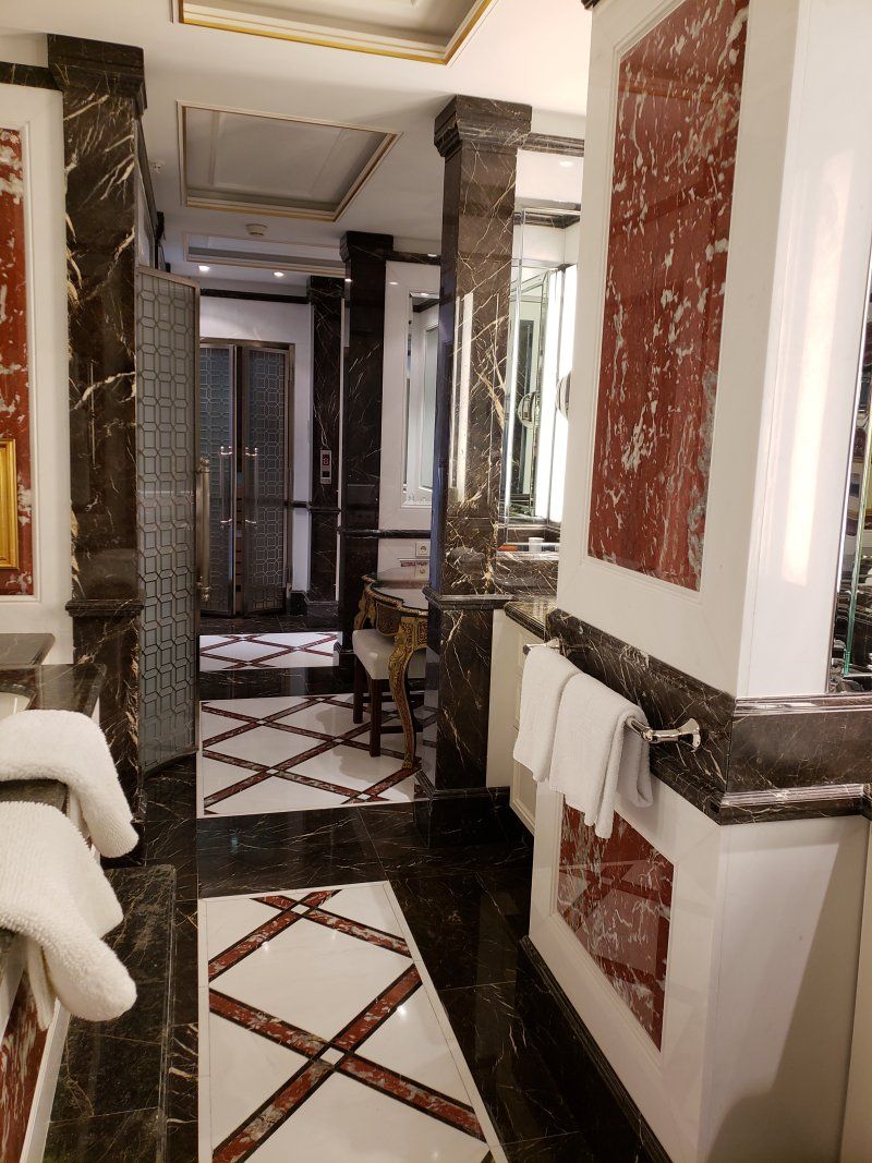 A bathroom with a black and white tile floor