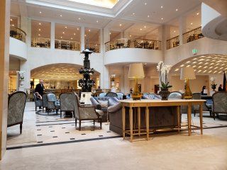 A large lobby of a hotel with a table and chairs