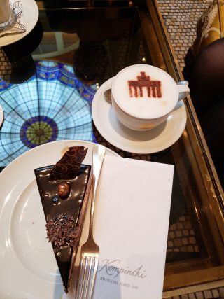 A slice of cake and a cup of coffee on a table