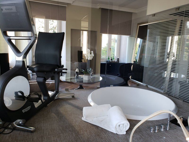 A bathroom with a bathtub and a exercise bike