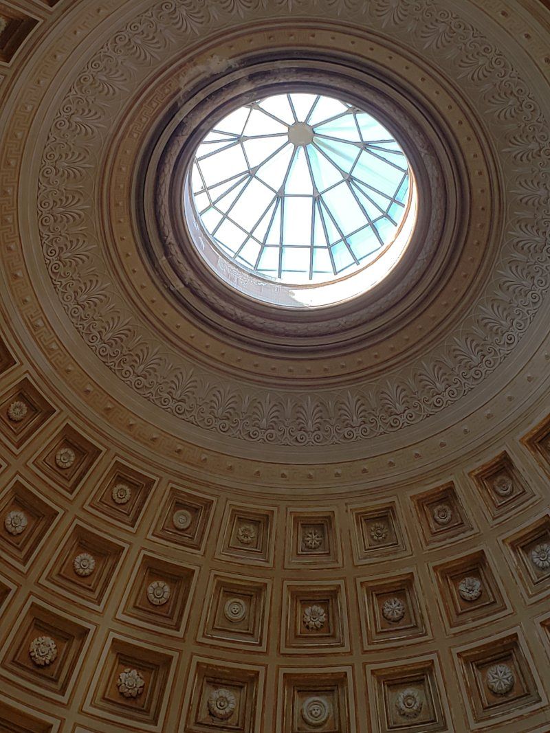 Looking up at the dome of a building with a skylight.