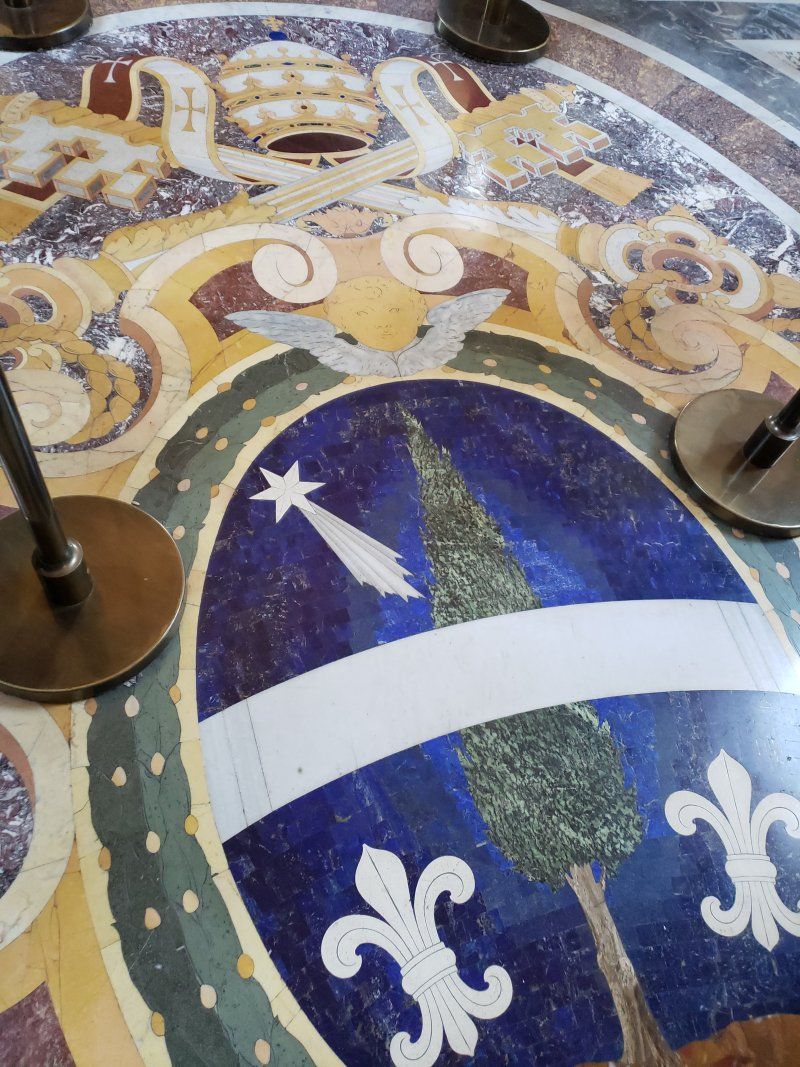 A colorful floor with a coat of arms on it