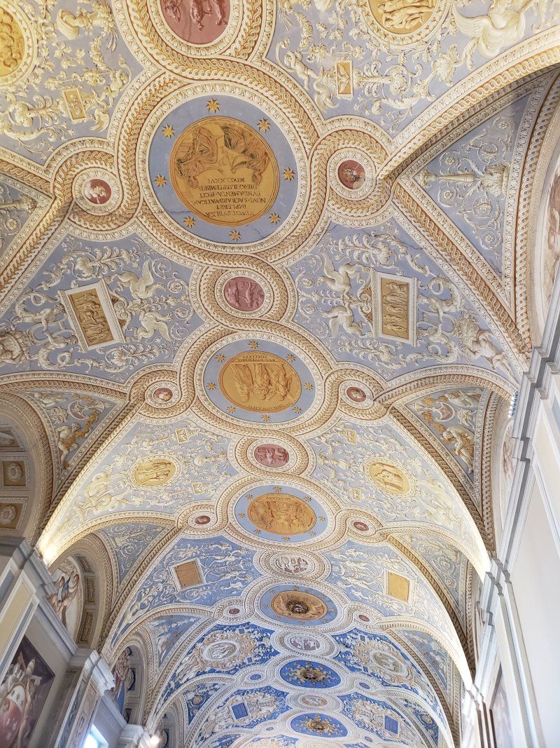 The ceiling of a building with a lot of paintings on it.