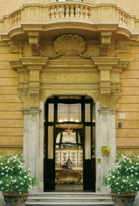 A building with a balcony and flowers in front of it