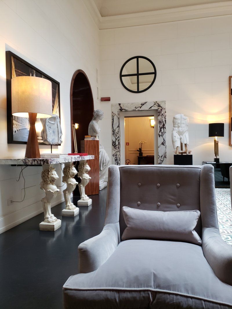 A living room with a chair and a mirror on the wall