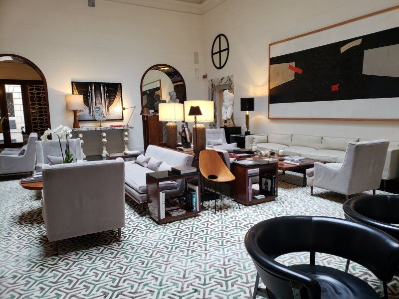 A living room filled with furniture and a painting on the wall