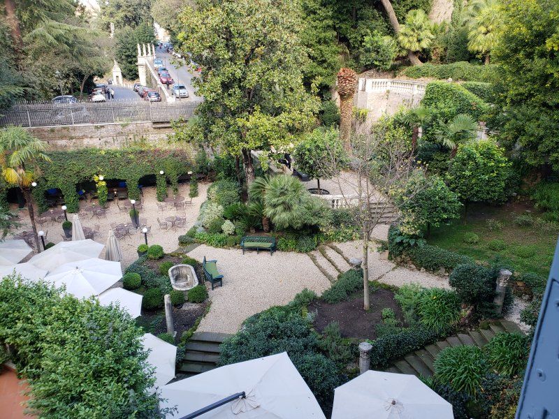 An aerial view of a garden with umbrellas and trees