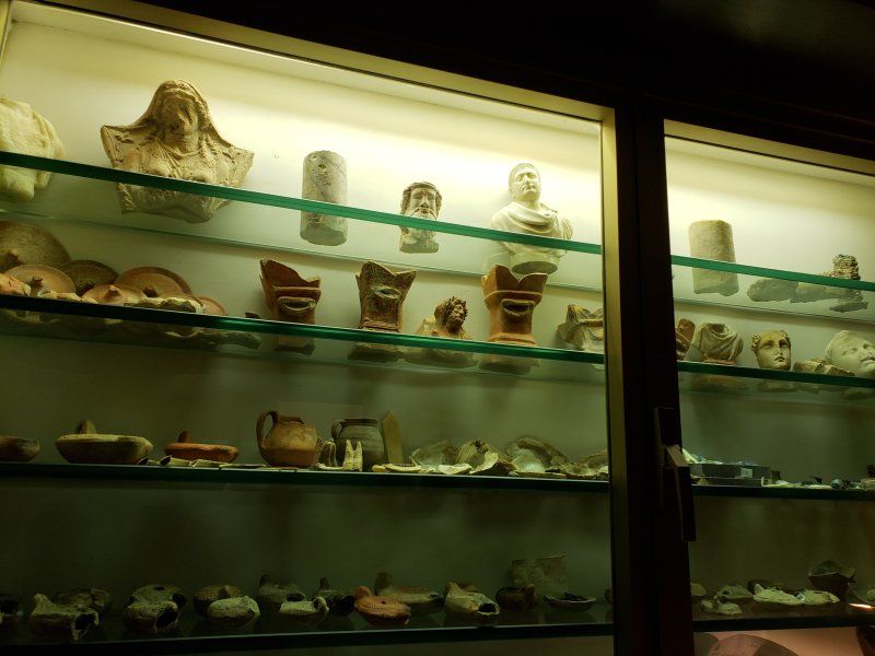 A display case filled with a variety of ancient artifacts