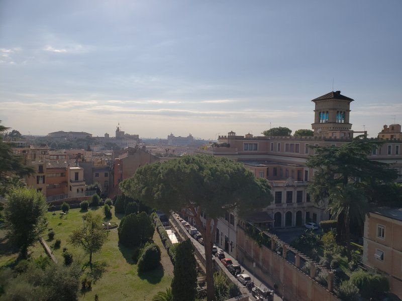 An aerial view of a city with a clock tower in the distance