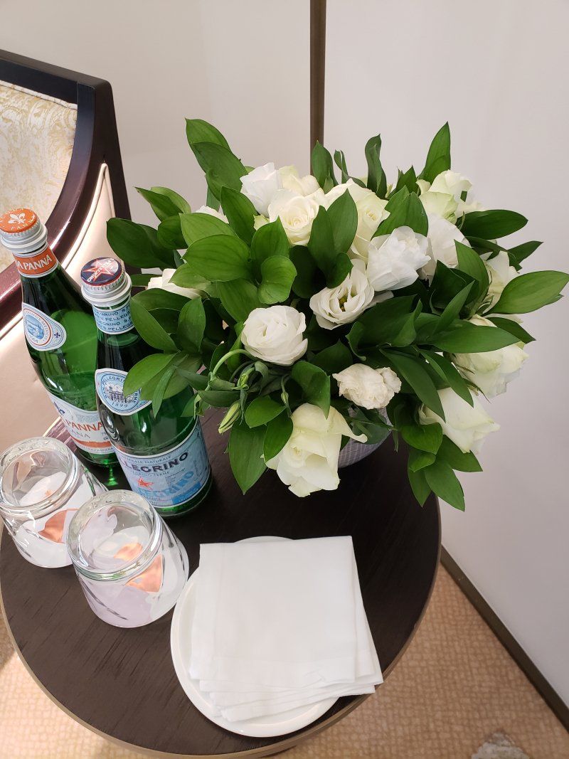 A table with bottles of water and flowers on it
