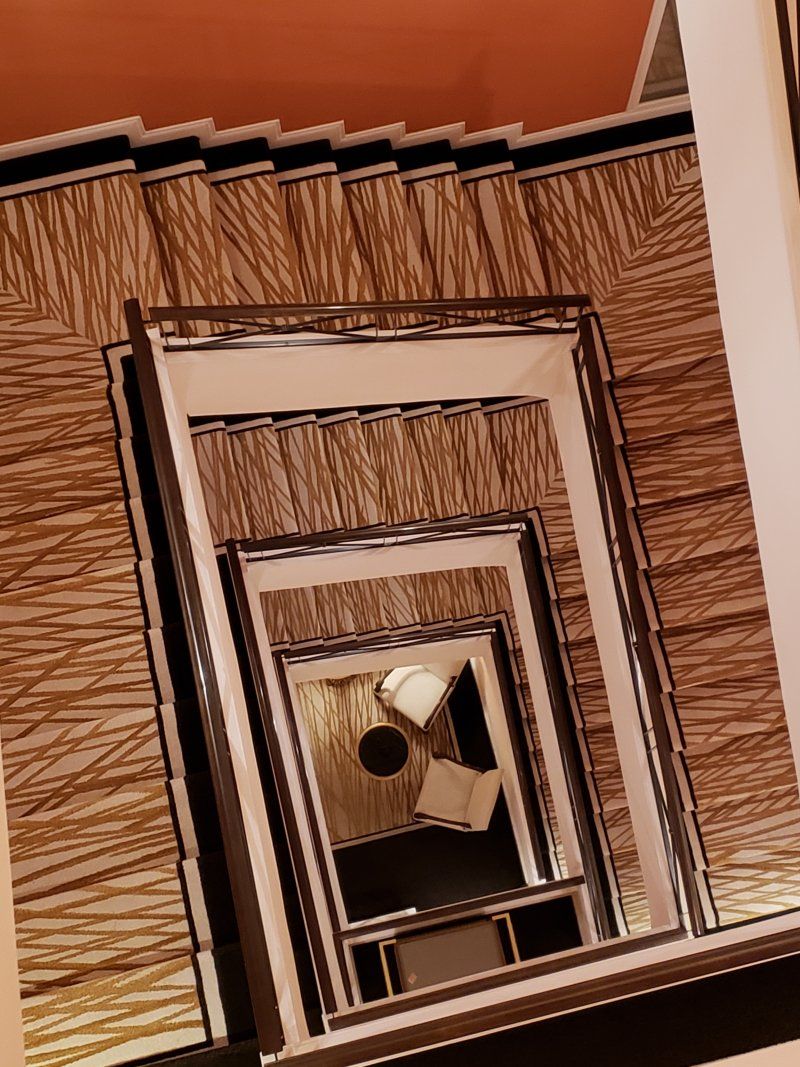 A staircase with a mirror on the bottom of it