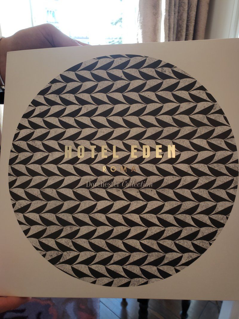 A person is holding a piece of paper that says hotel eden