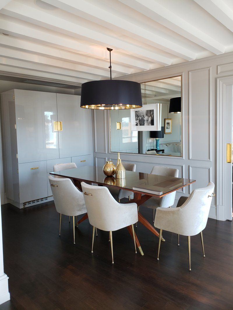 A dining room with a table and chairs and a chandelier