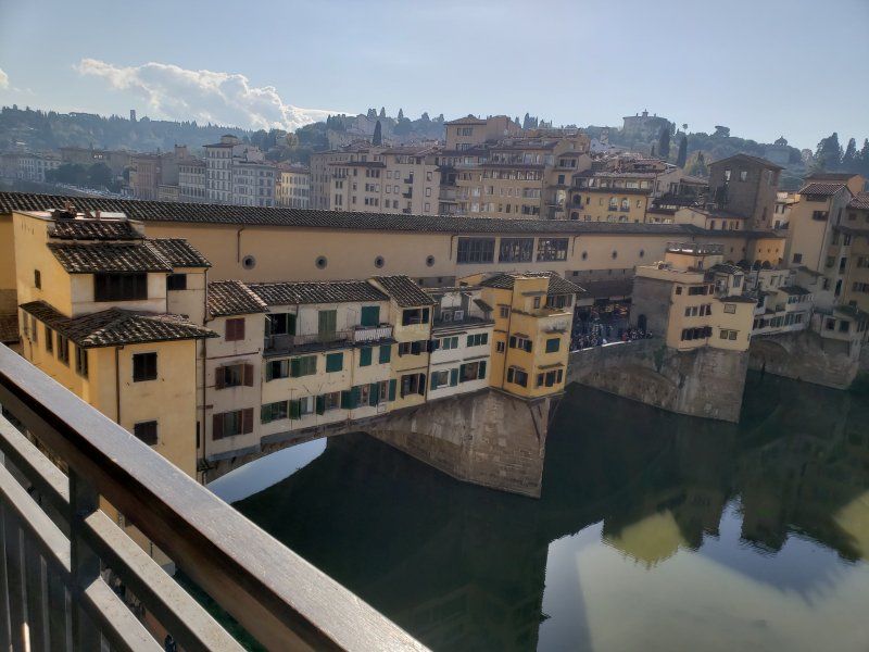 A bridge over a river with buildings in the background