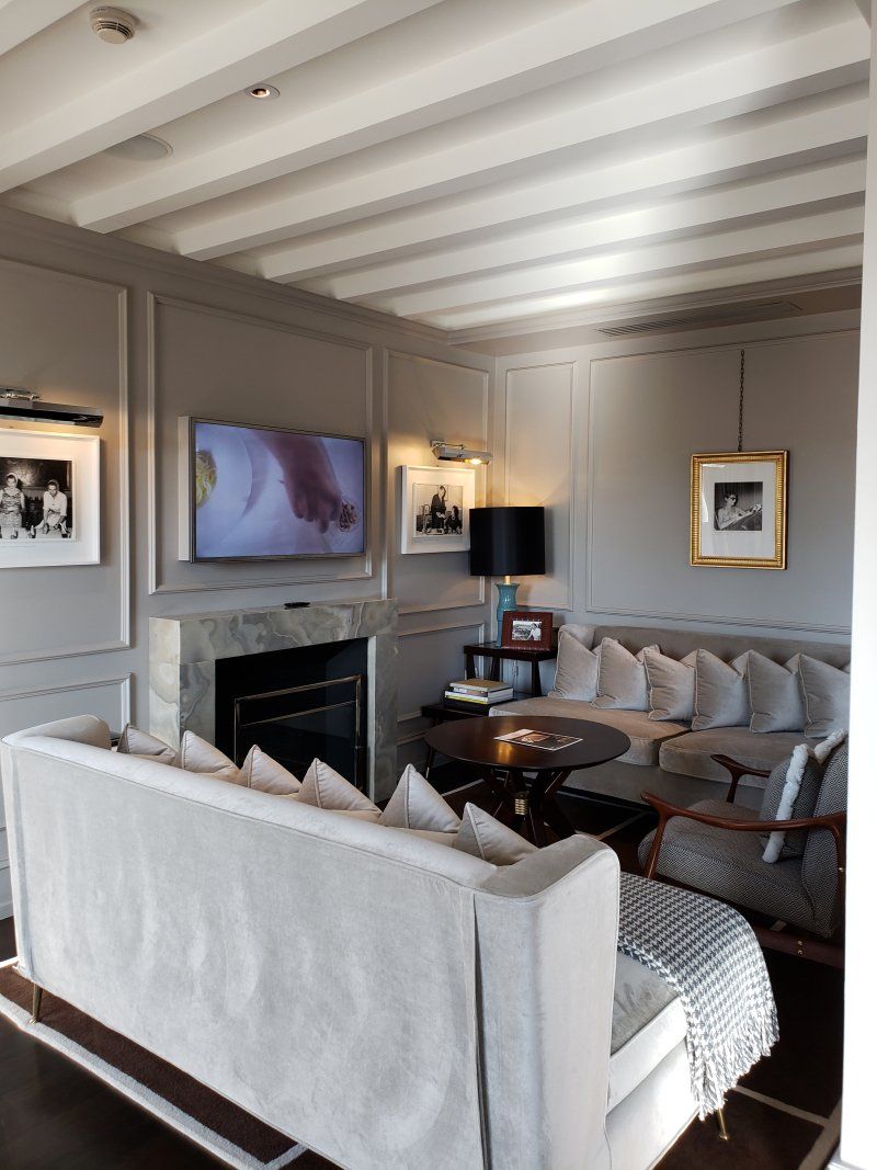 A living room with a couch a fireplace and a flat screen tv