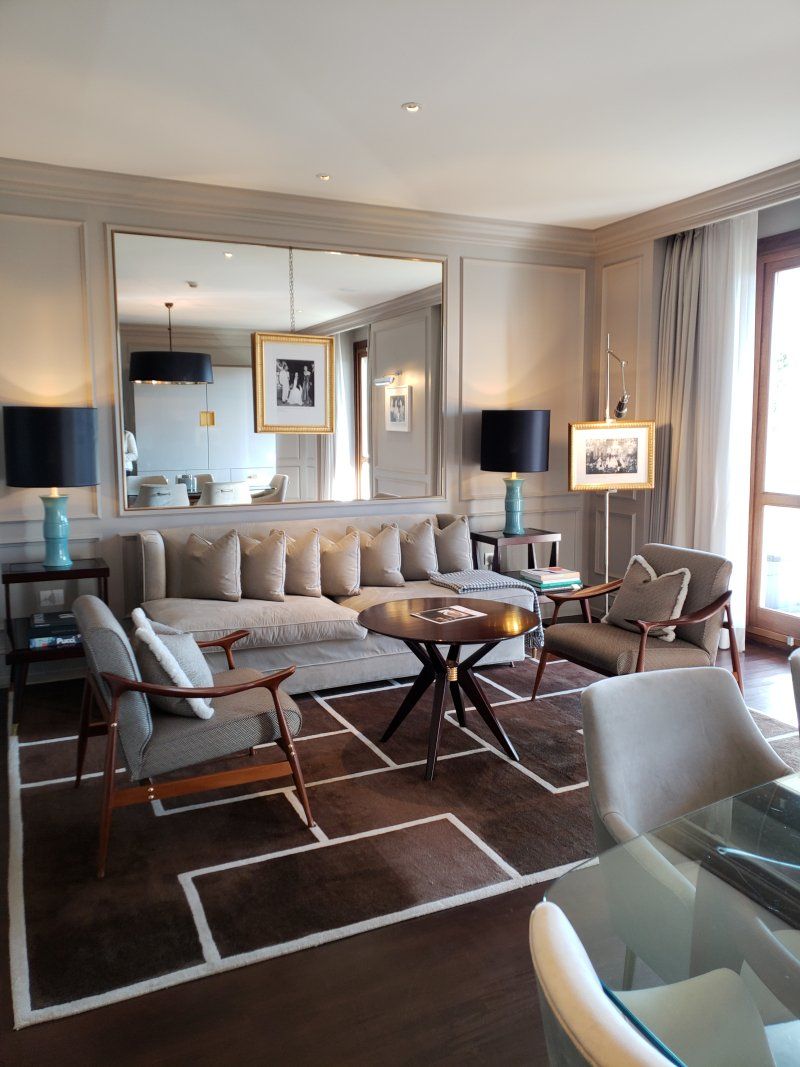 A living room filled with furniture and a large mirror
