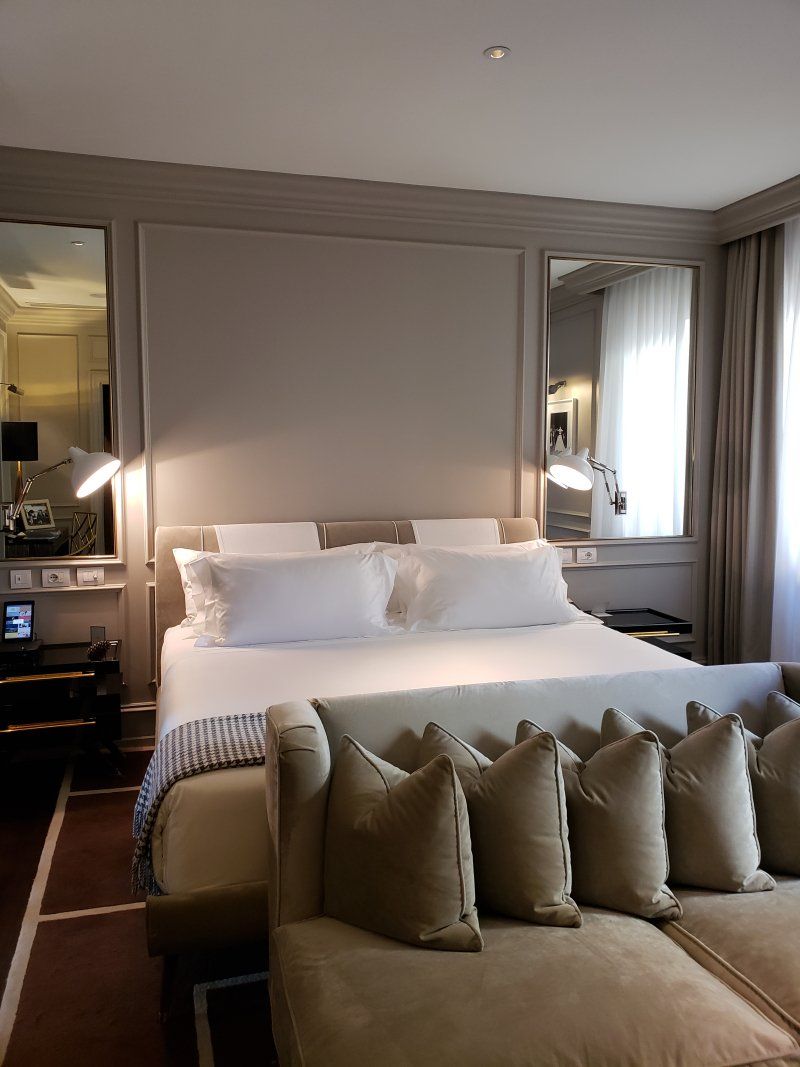 A hotel room with a large bed and a couch.