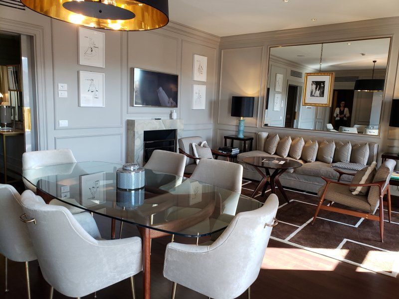 A living room with a glass table and chairs