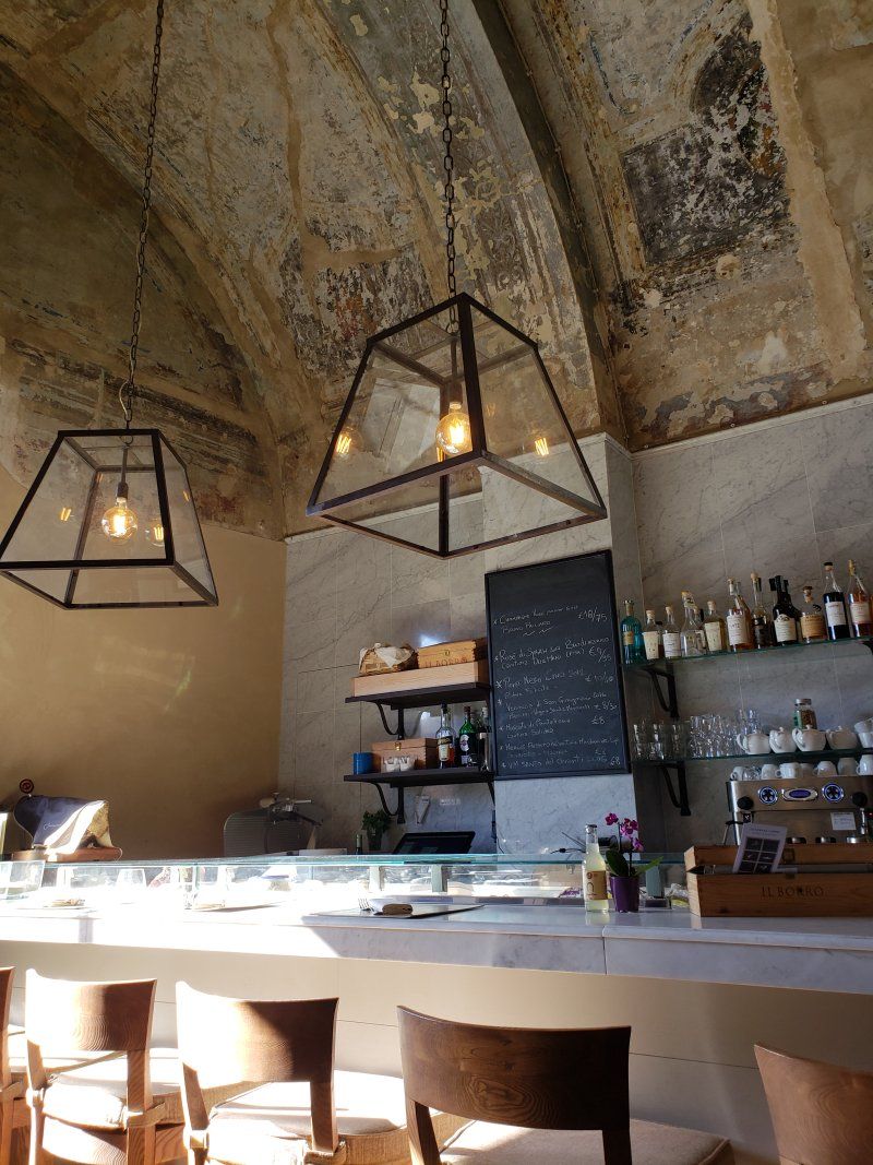 A restaurant with tables and chairs and a ceiling with a vaulted ceiling