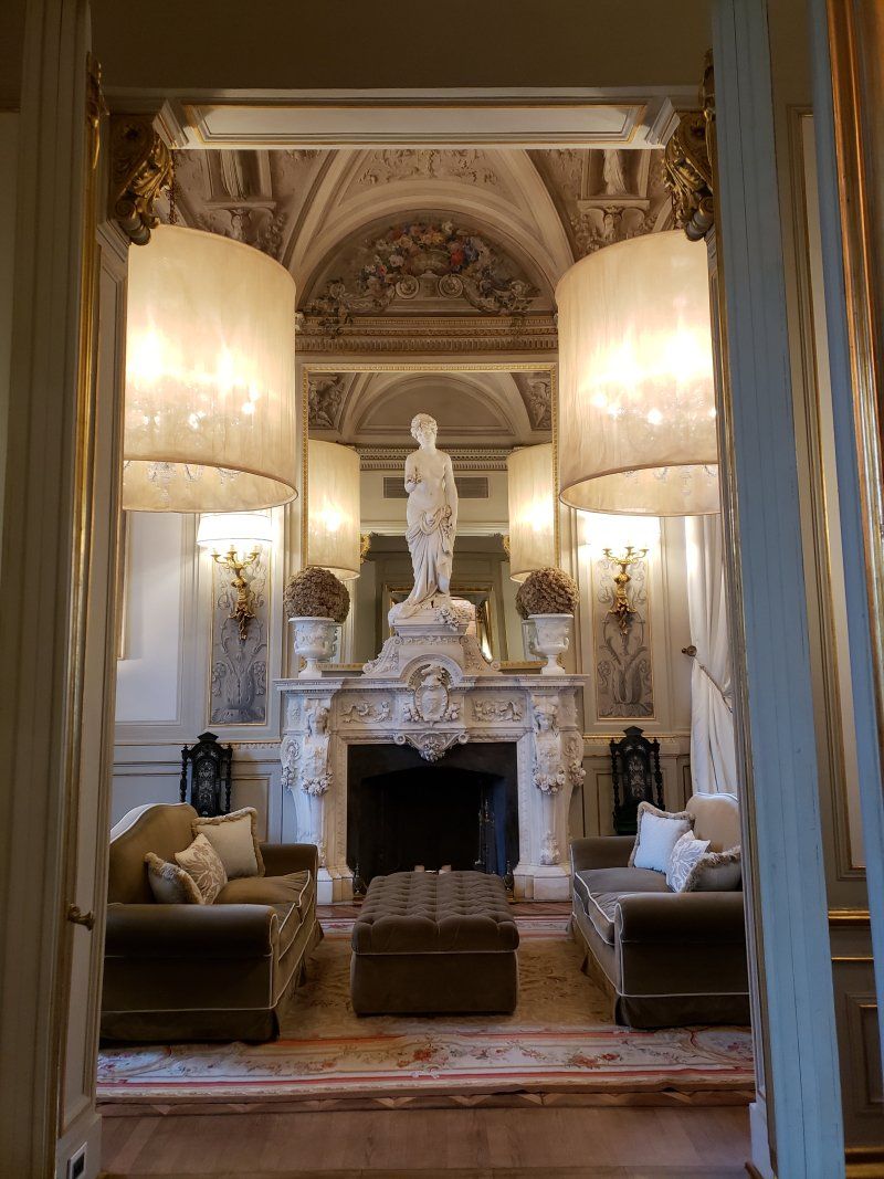 A living room with a fireplace and a statue