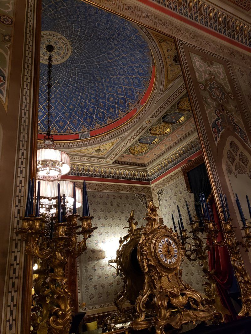 A room with a clock and candles in it