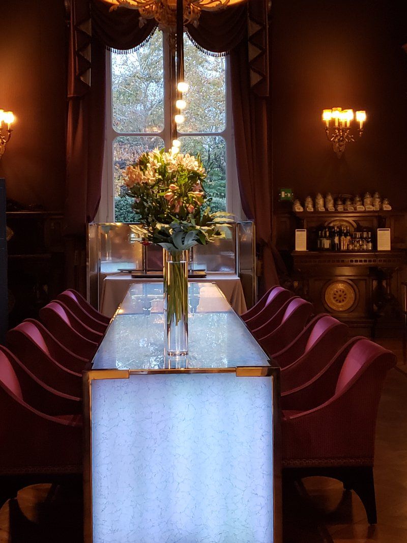 A long table with a vase of flowers on it