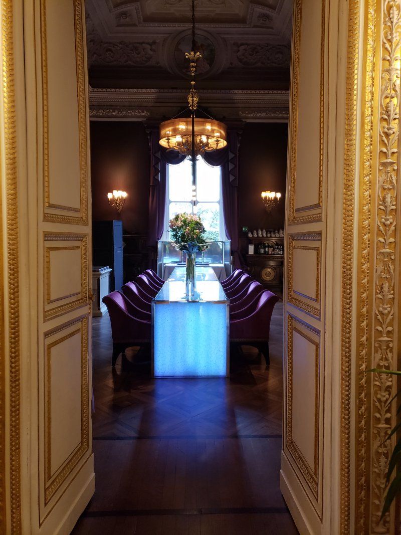 A dining room with a long table and chairs