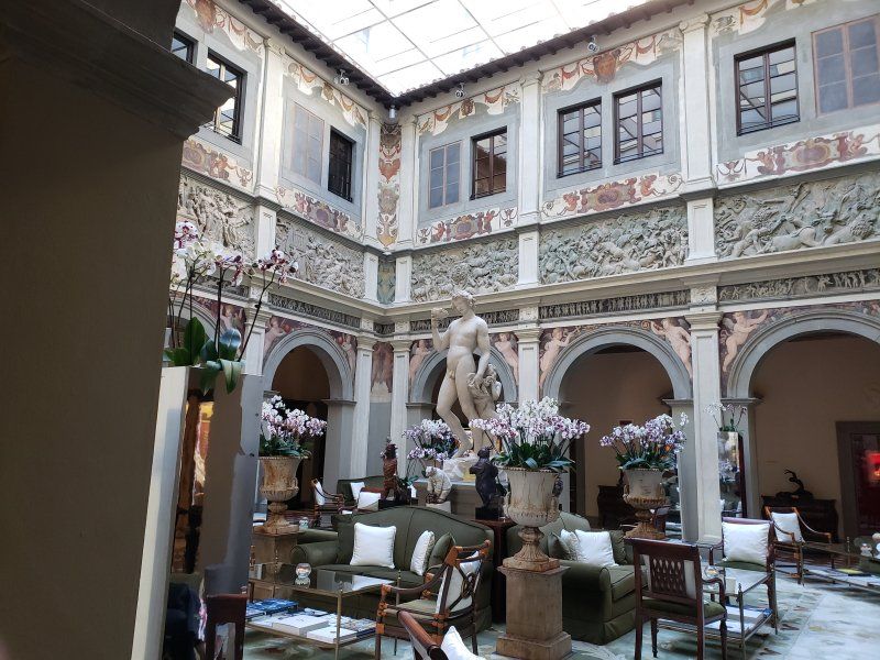 A large building with a statue in the middle of it