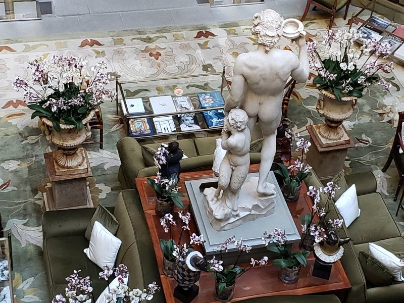 An aerial view of a living room with a statue in the middle