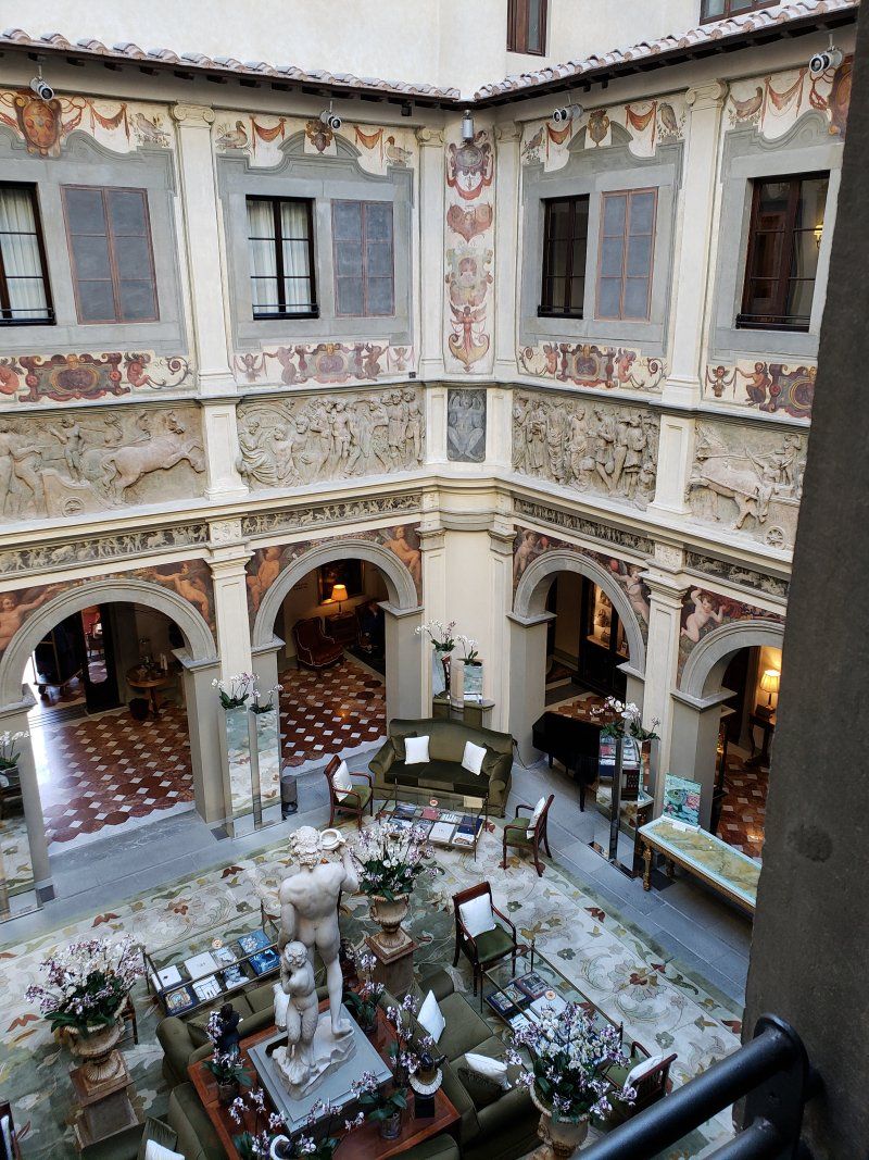 An aerial view of a large courtyard filled with furniture and arches.