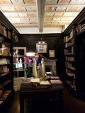 A library filled with lots of books and a table.