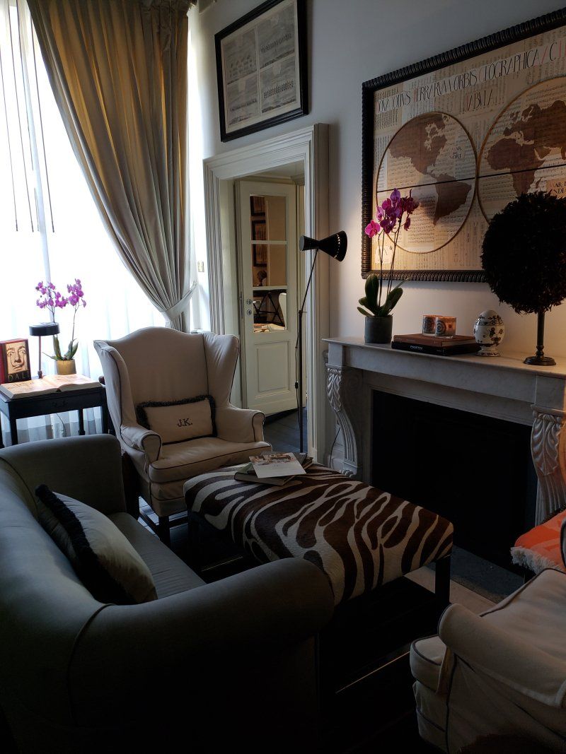 A living room with a fireplace and a map on the wall