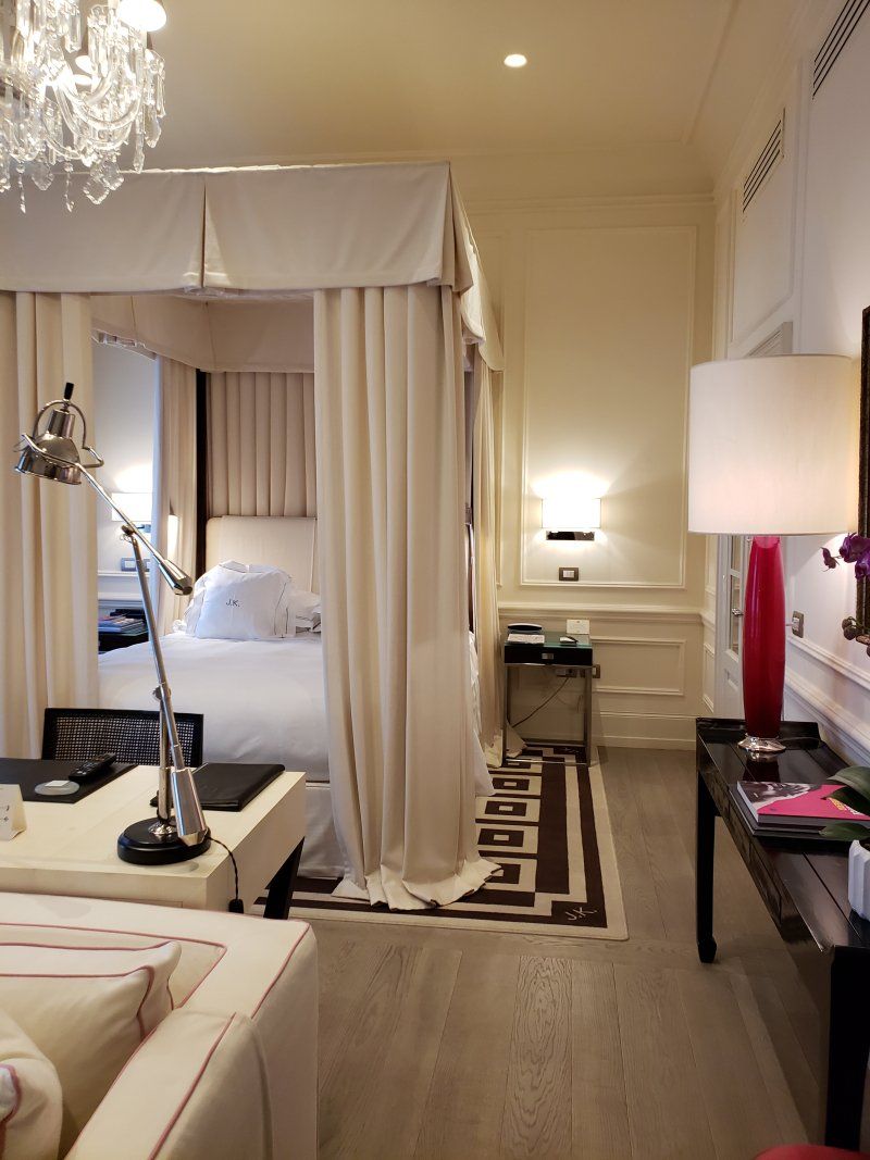 A bedroom with a canopy bed and a couch