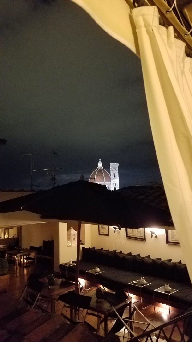 A view of a church from a restaurant at night