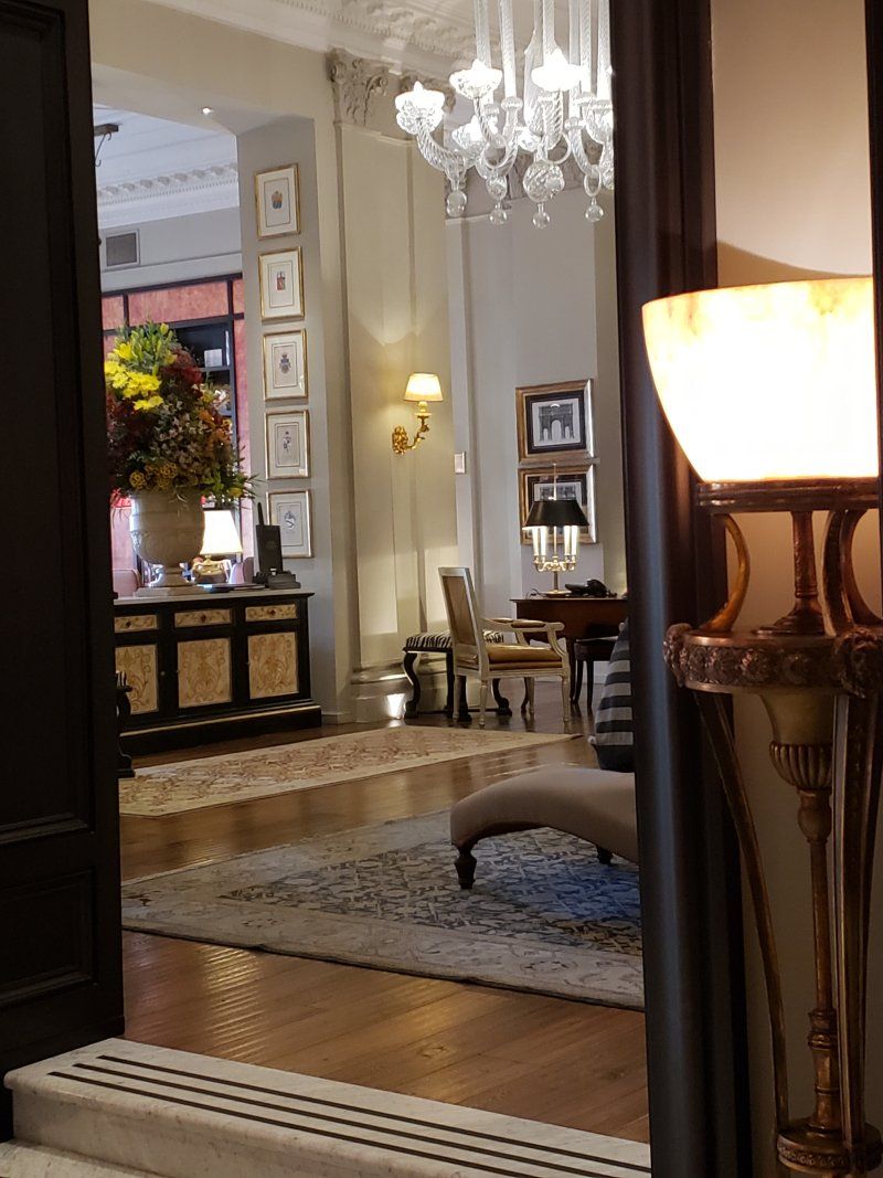 A room with a lamp and a vase of flowers