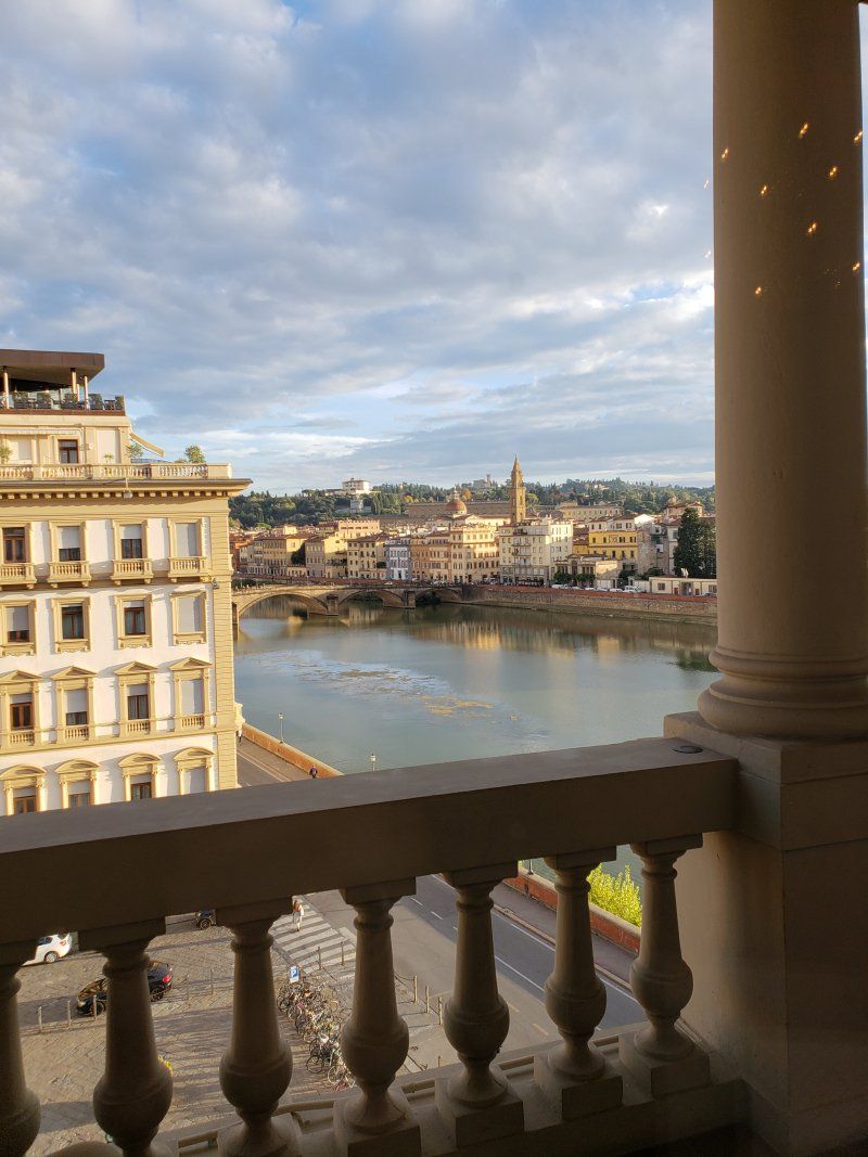 A balcony with a view of a city and a river