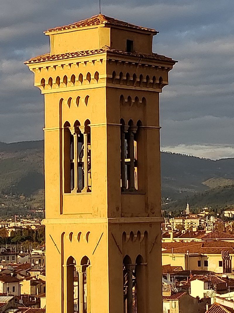 A large yellow building with a clock tower on top of it
