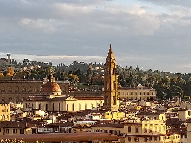 An aerial view of a city with a clock tower in the middle