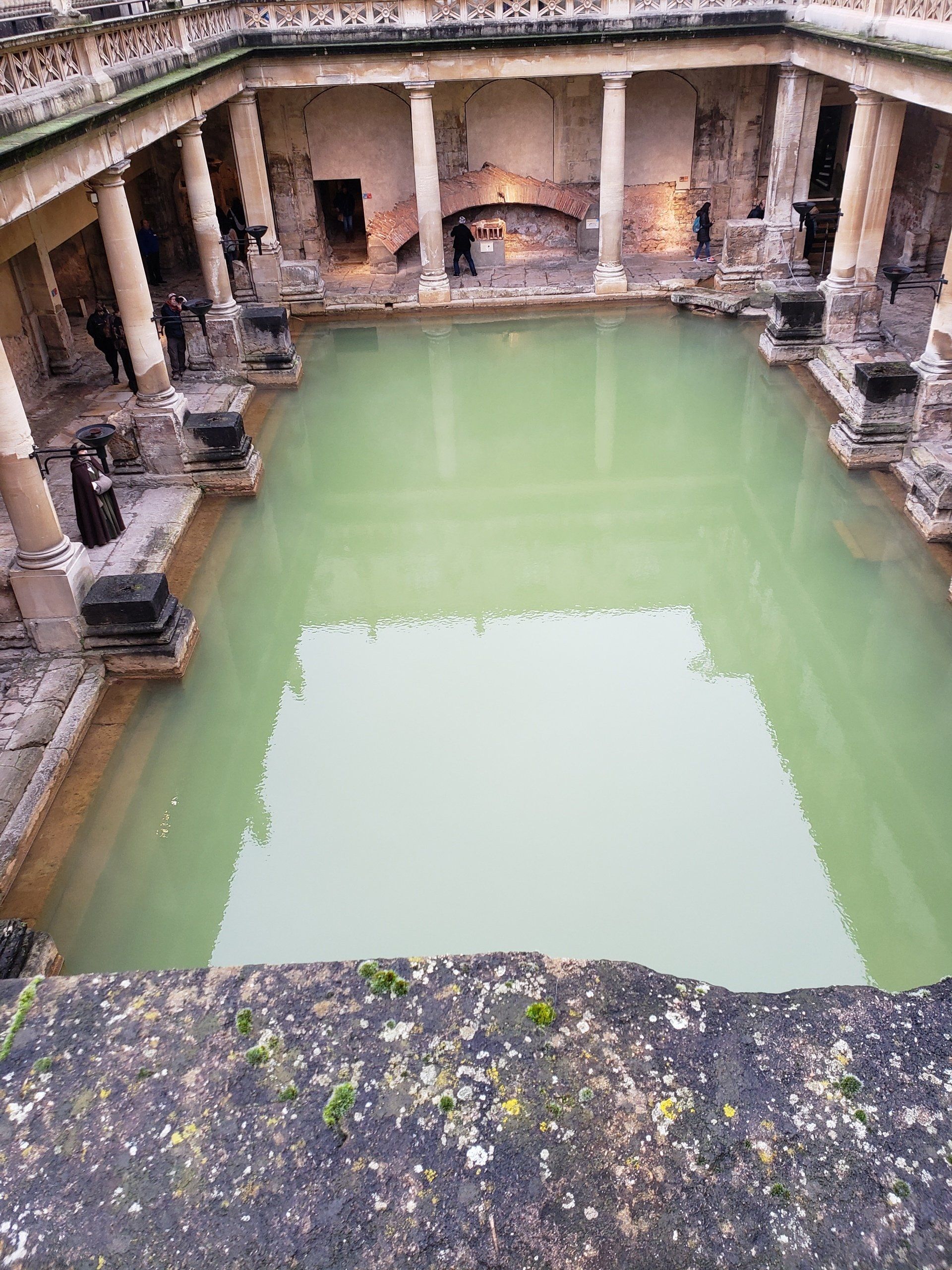 There is a large pool of water in the middle of a building.