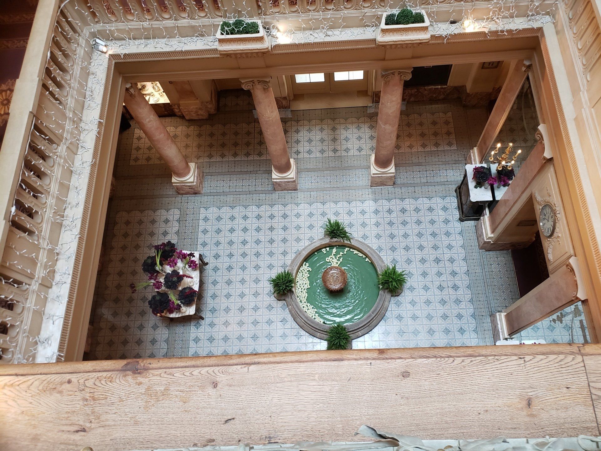 An aerial view of a courtyard with a fountain in the middle.