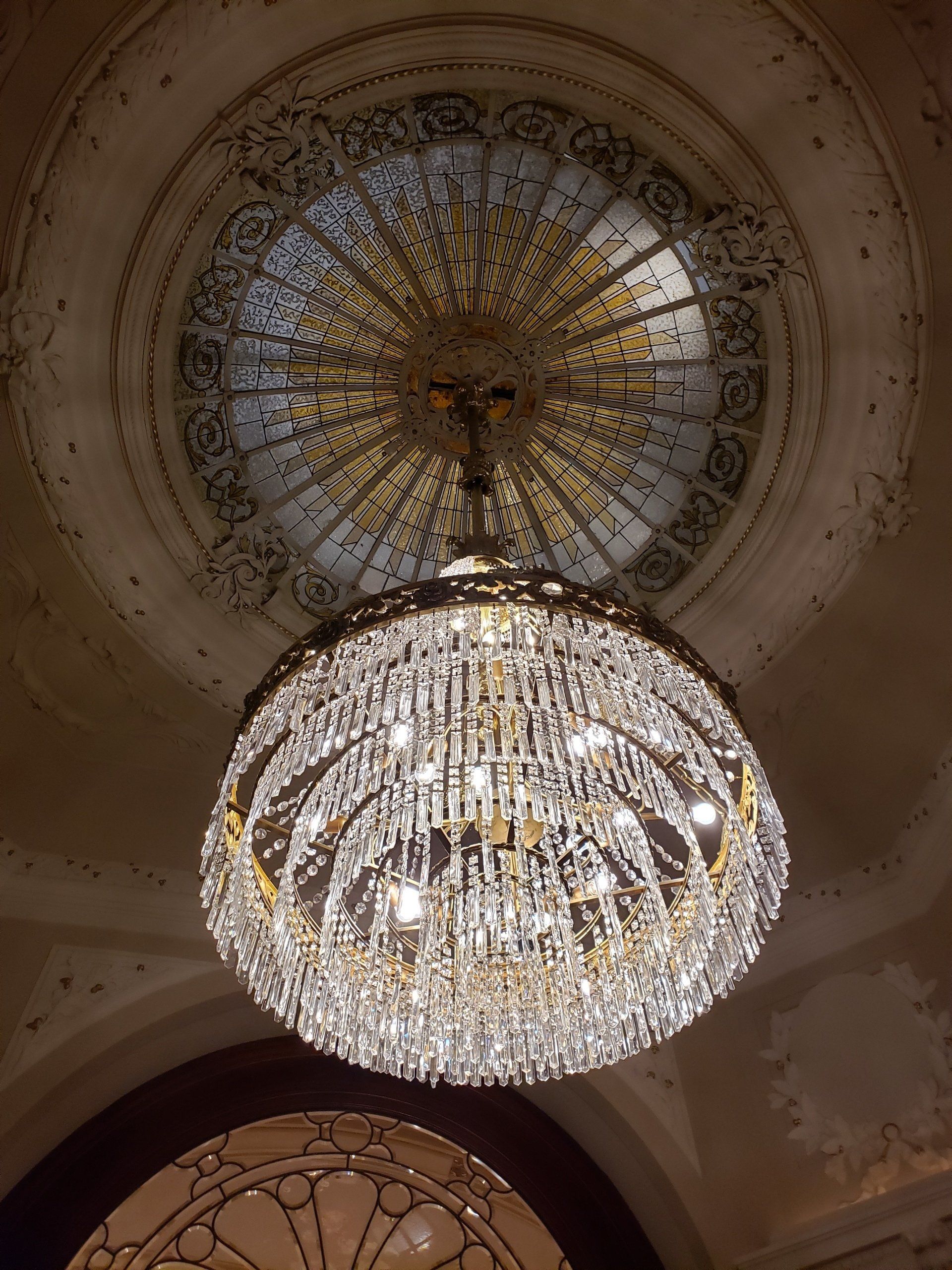 A large chandelier is hanging from the ceiling of a building