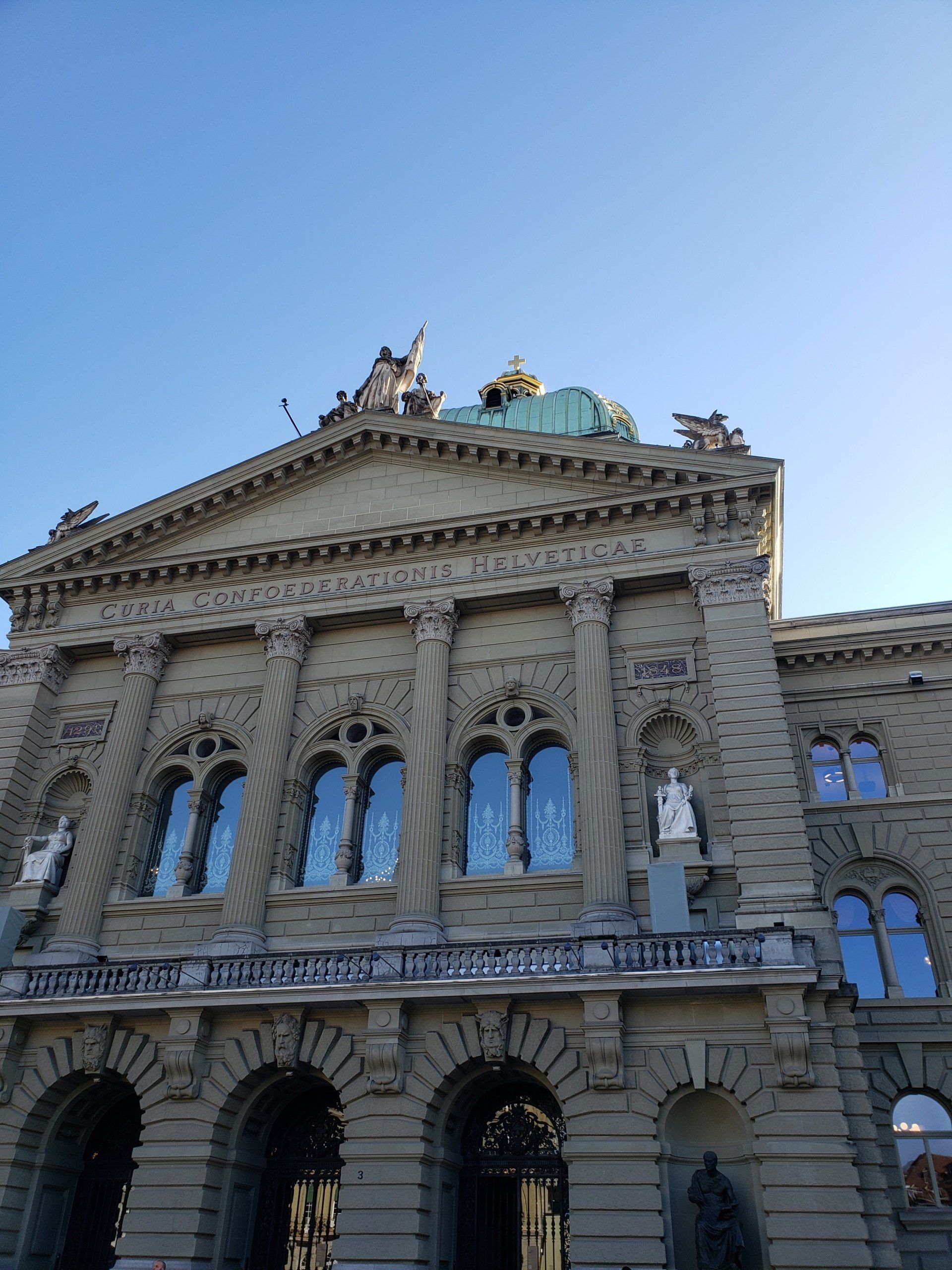 A large building with a statue on top of it.
