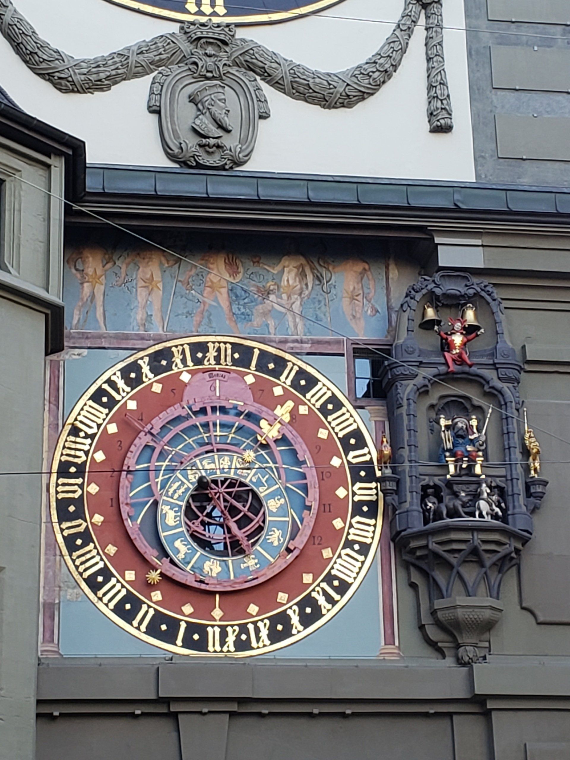 A clock on the side of a building shows the time as 4:20