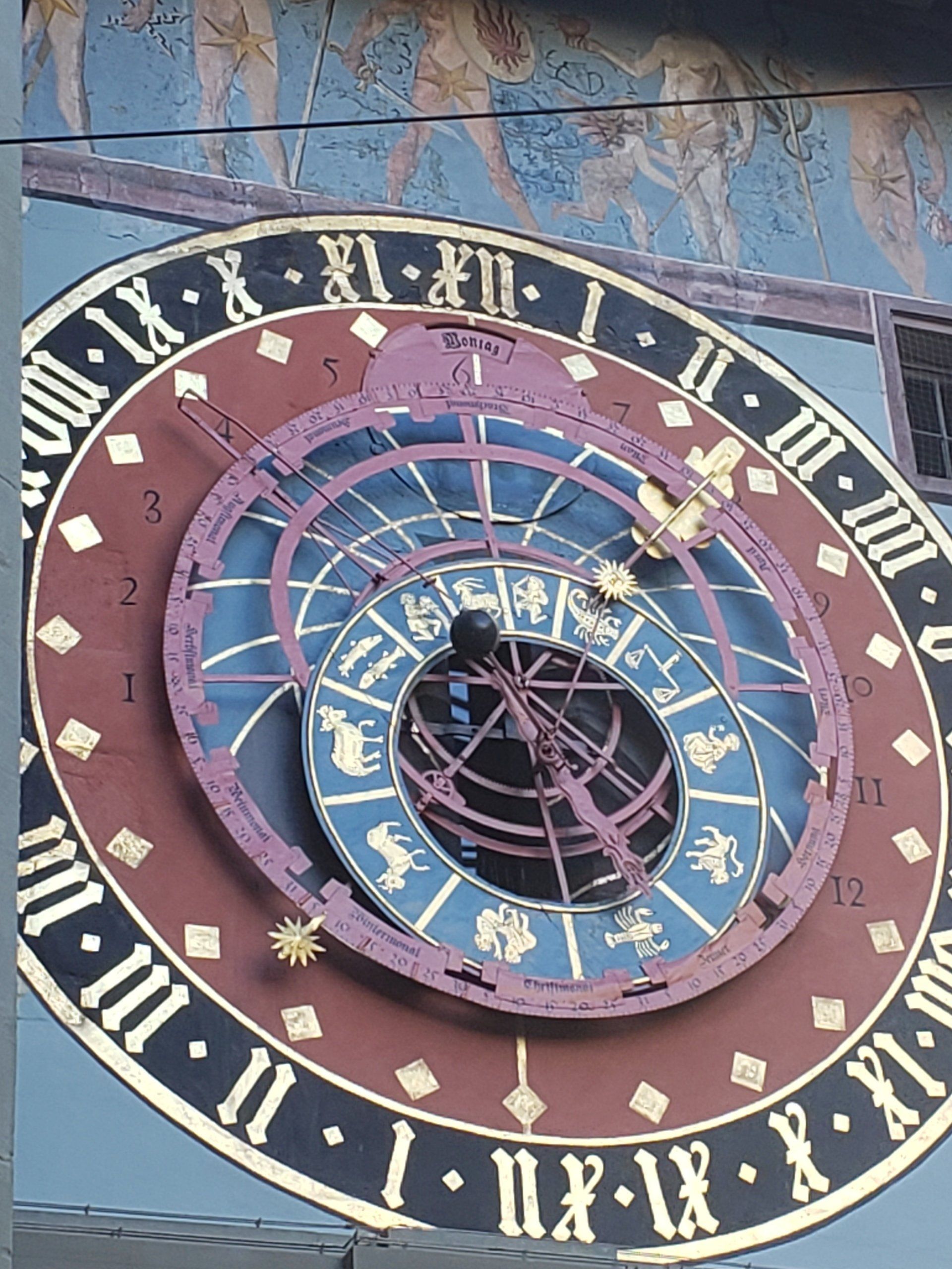 A large clock on the side of a building with roman numerals